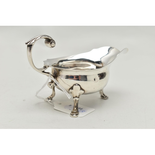 243 - A GEORGE III SMALL SILVER SAUCE BOAT OF SHAPED OVAL FORM, 'S' scroll handle, wavy rim, on three cabr... 