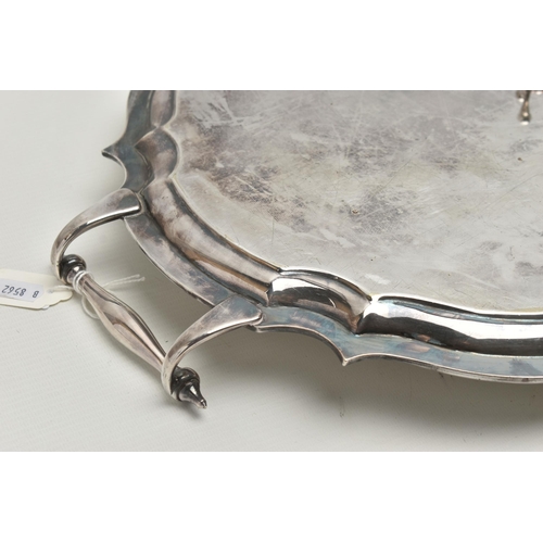 253 - AN EPNS TWIN HANDLED TRAY OF WAVY OVAL FORM AND THREE PLATED KNIFE RESTS, the tray with scrolled ove... 