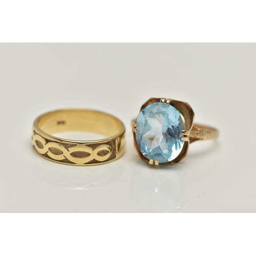 27 - TWO 9CT GOLD RINGS, the first designed with a double four claw set, oval cut light blue topaz, in an... 