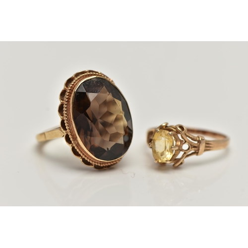 29 - TWO GEMSTONE SET RINGS, the first a large oval smoky quartz, measuring approximately length 18.7mm x... 