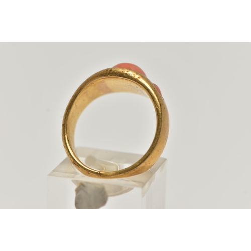 4 - A YELLOW METAL CORAL RING, designed with three circular cut coral cabochon inlayed to a yellow metal... 