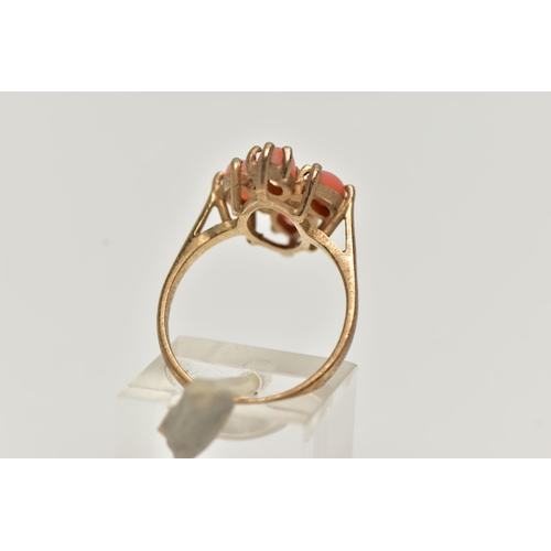 53 - A 9CT GOLD CORAL RING, four marquise cabochon coral stones set as a cluster in a yellow gold mount, ... 