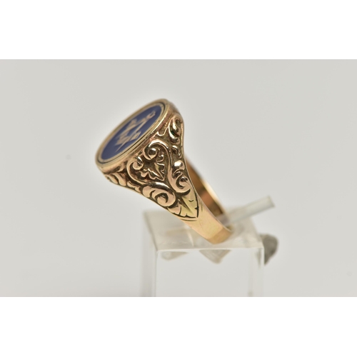 57 - A HEAVY 9CT GOLD MASONIC ENAMEL RING, of an oval form decorated with blue enamel, scrolling embossed... 