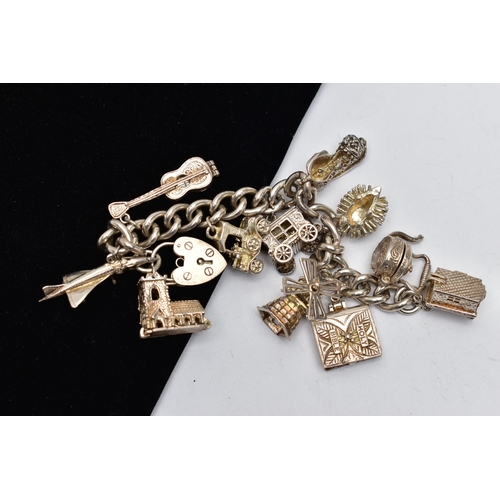 76 - A SILVER CHARM BRACELET, a curb link bracelet hallmarked silver London, fitted with a heart padlock ... 