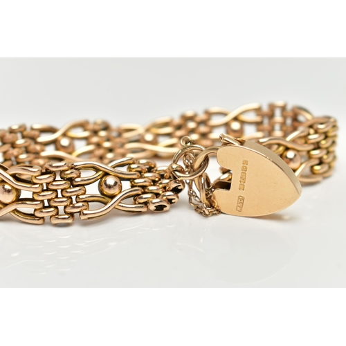 8 - A 15CT YELLOW GOLD, WIDE GATE BRACELET, featuring textured oval links and ball detail, fitted with a... 