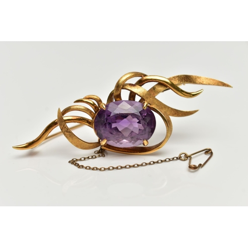 1 - A YELLOW METAL AMETHYST SPRAY BROOCH, designed with a four claw set, oval cut amethyst, within a spr... 