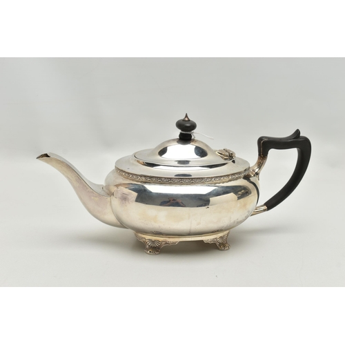 231 - A GEORGE V SILVER TEA POT OF SHAPED OVAL FORM, ebonised fitments, foliate cast rim and feet, makers ... 