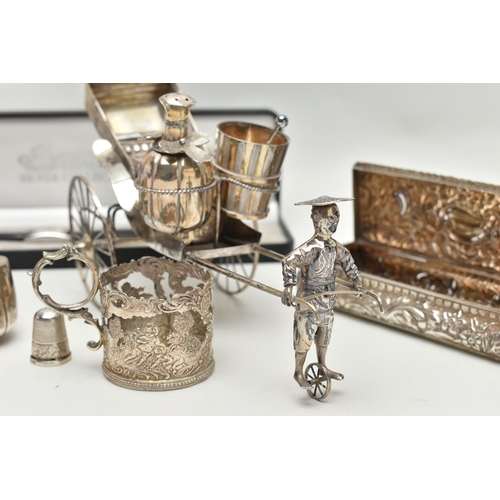 237 - A CHINESE WHITE METAL CRUET SET IN THE FORM OF A RICKSHAW BEING PULLED BY A MAN, the salt of pail fo... 