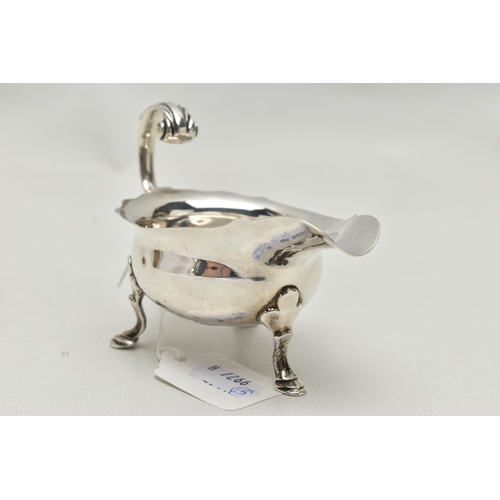 243 - A GEORGE III SMALL SILVER SAUCE BOAT OF SHAPED OVAL FORM, 'S' scroll handle, wavy rim, on three cabr... 