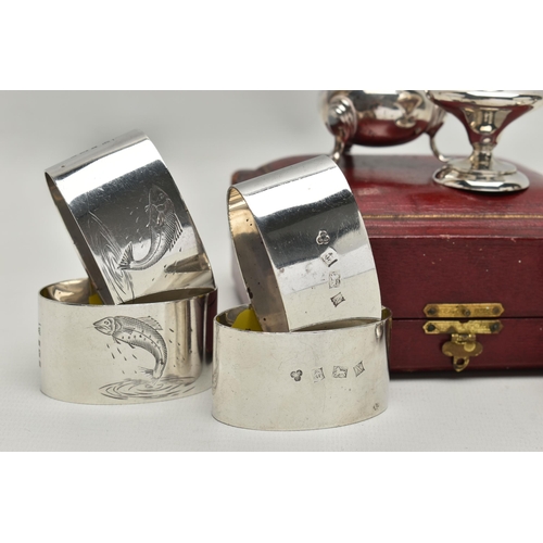 254 - A CASED PAIR OF EDWARDIAN SILVER PEPPERETTES, FOUR OVAL SILVER NAPKIN RINGS AND A MATCHED PAIR OF PE... 