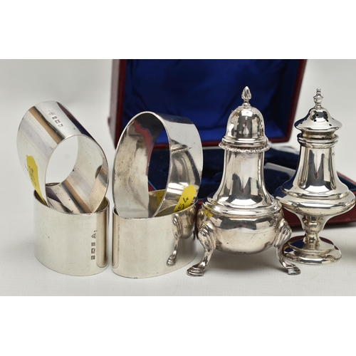 254 - A CASED PAIR OF EDWARDIAN SILVER PEPPERETTES, FOUR OVAL SILVER NAPKIN RINGS AND A MATCHED PAIR OF PE... 