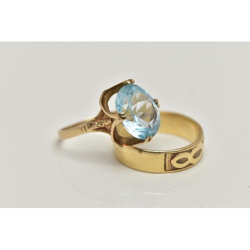 27 - TWO 9CT GOLD RINGS, the first designed with a double four claw set, oval cut light blue topaz, in an... 