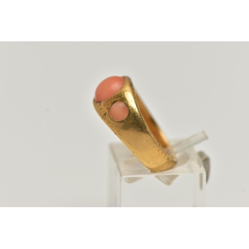 4 - A YELLOW METAL CORAL RING, designed with three circular cut coral cabochon inlayed to a yellow metal... 