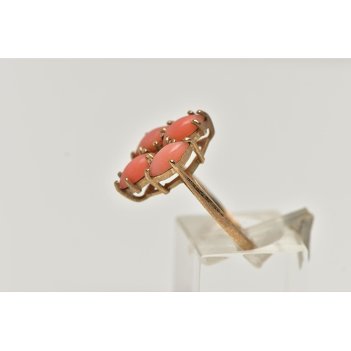 53 - A 9CT GOLD CORAL RING, four marquise cabochon coral stones set as a cluster in a yellow gold mount, ... 