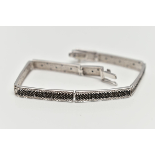 69 - A 9CT GOLD DIAMOND BRACELET, a white gold line bracelet comprised of eight panels, detailed with a c... 