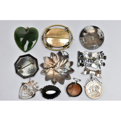 98 - AN ASSORTMENT OF PENDANTS AND BROOCHES, the first a heart shaped nephrite jade pendant, fitted with ... 