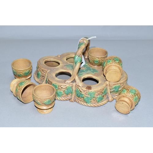 351 - A NINETEENTH CENTURY MAJOLICA STAND CONTAINING SIX EGG CUPS, the stand of lobed form with twisting h... 