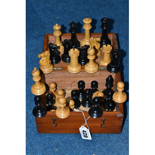 428 - A BOXED SET OF EBONY AND BOXWOOD CHESS PIECES, c1900, weighted pieces, one knight and one rook from ... 