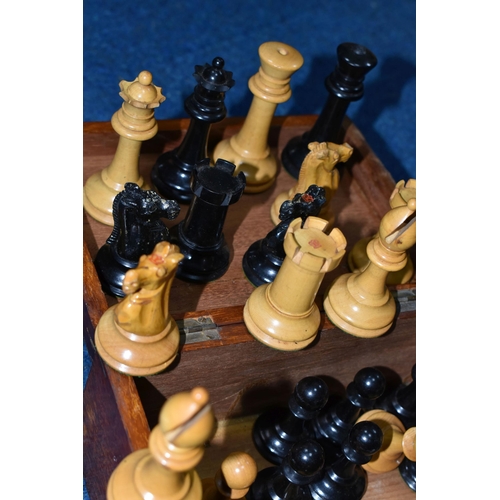 428 - A BOXED SET OF EBONY AND BOXWOOD CHESS PIECES, c1900, weighted pieces, one knight and one rook from ... 