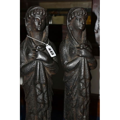 445 - A PAIR OF CAST IRON FIGURES, the female figures of classical style, each standing on a square plinth... 