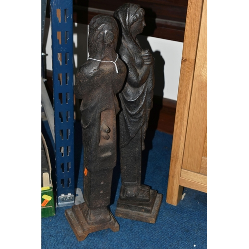 445 - A PAIR OF CAST IRON FIGURES, the female figures of classical style, each standing on a square plinth... 