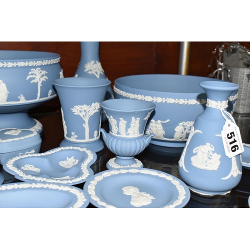 516 - A COLLECTION OF WEDGWOOD BLUE JASPERWARE, comprising two bud vases, a jug (soft padding stuck to bas... 