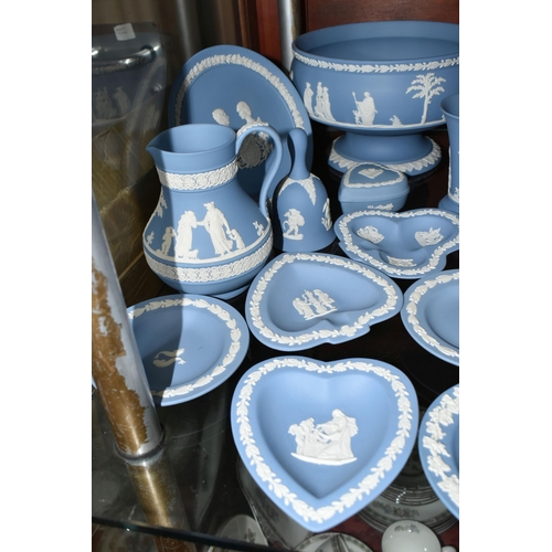 516 - A COLLECTION OF WEDGWOOD BLUE JASPERWARE, comprising two bud vases, a jug (soft padding stuck to bas... 