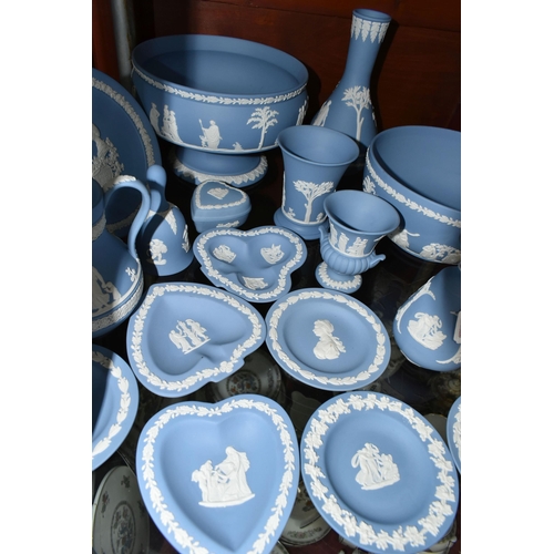 516 - A COLLECTION OF WEDGWOOD BLUE JASPERWARE, comprising two bud vases, a jug (soft padding stuck to bas... 