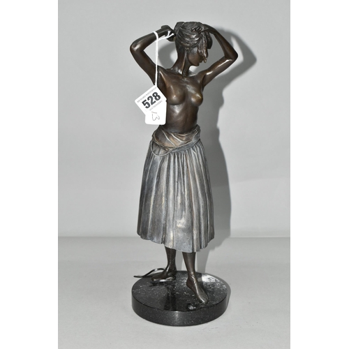 528 - A PATINATED BRONZE FIGURE OF A BALLERINA, height 36cm, a partially clad young woman fixing her hair ... 