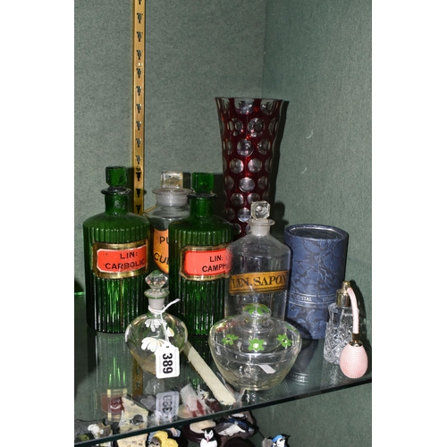 389 - A GROUP OF CHEMISTS BOTTLES AND OTHER GLASS WARES, comprising four labelled chemists bottles - two b... 