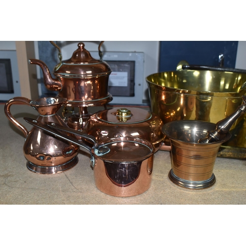 411 - A COLLECTION OF COPPERWARE AND BRASS, comprising a copper spirit kettle with a wicker handle, large ... 