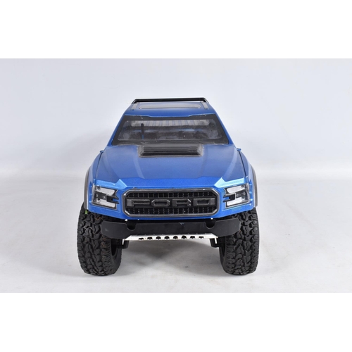 2 - A TRAXXAS REMOTE CONTROLLED FORD PICKUP TRUCK, heavy built frame, blue painted body with black and s... 