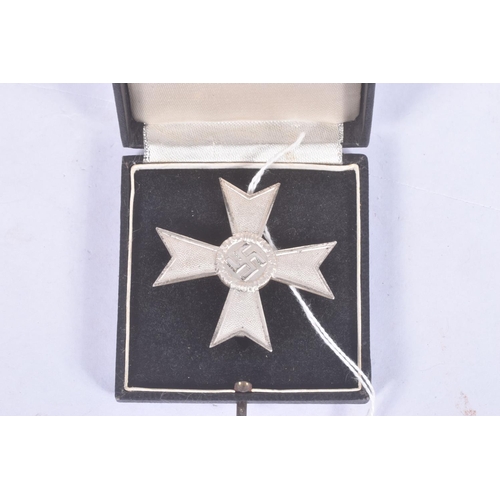 294 - A GERMAN THIRD REICH FIRST CLASS WAR MERIT CROSS WITHOUT SWORDS, this merit cross is silver in colou... 