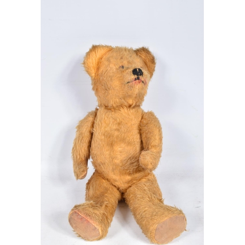 106 - A GOLDEN PLUSH TEDDY BEAR, amber and black plastic eyes, vertically stitched nose, jointed body with... 