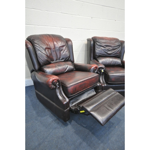 1217 - TWO OXBLOOD LEATHER ARMCHAIRS, one chair manual reclining, width of outer arm 91cm (condition:- mech... 