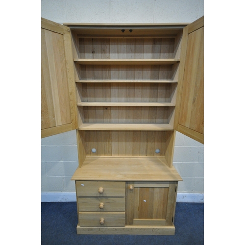 1241 - A LIGHT OAK DRESSER, top section with double panelled doors, over a base with three drawers, beside ... 