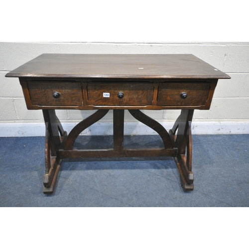 1263 - AN ARTS AND CRAFTS OAK TRESTLE SIDE TABLE, with three drawers, on a shaped base united by a shaped s... 