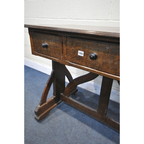 1263 - AN ARTS AND CRAFTS OAK TRESTLE SIDE TABLE, with three drawers, on a shaped base united by a shaped s... 