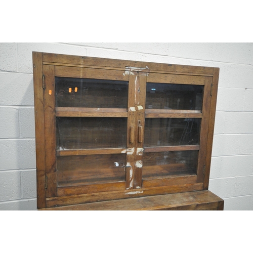 1273 - AN EARLY 20TH CENTURY OAK GLAZED CUPBOARD, above double panelled cupboard doors, width 122cm x depth... 