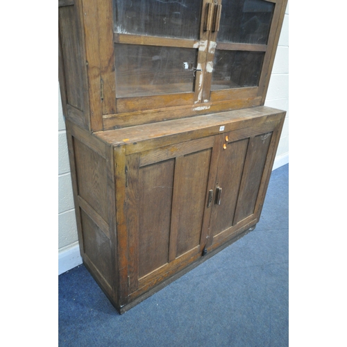 1273 - AN EARLY 20TH CENTURY OAK GLAZED CUPBOARD, above double panelled cupboard doors, width 122cm x depth... 