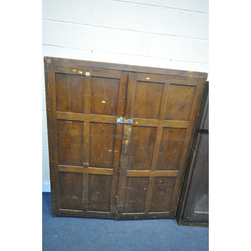 1274 - AN OPPOSING PAIR OF EARLY 20TH CENTURY STAINED PINE PANELLED SINGLE DOOR CUPBOARD, enclosing an arra... 