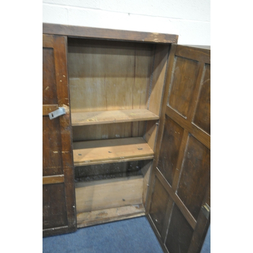 1274 - AN OPPOSING PAIR OF EARLY 20TH CENTURY STAINED PINE PANELLED SINGLE DOOR CUPBOARD, enclosing an arra... 