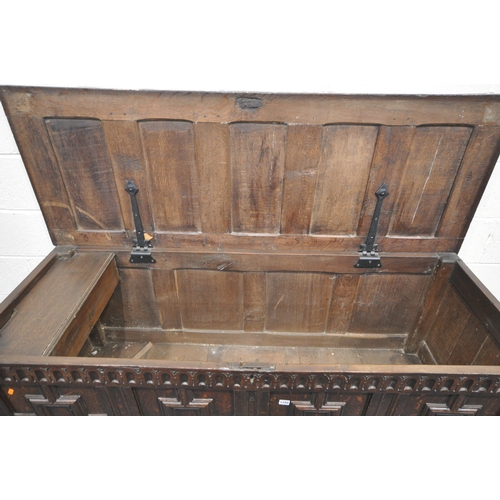 1288 - A LONG GEORGIAN OAK PANEL COFFER, with four Geometric panels, with a hinged storage to the left side... 