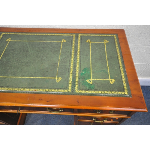 1292 - A YEWWOOD PEDESTAL DESK, with a green leather writing surface, and an arrangement of eight drawers, ... 