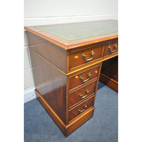 1292 - A YEWWOOD PEDESTAL DESK, with a green leather writing surface, and an arrangement of eight drawers, ... 