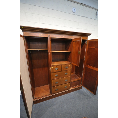 1294 - AN EDWARDIAN MAHOGANY COMPACTUM WARDROBE, with two bevelled mirror doors, flanking two small cupboar... 