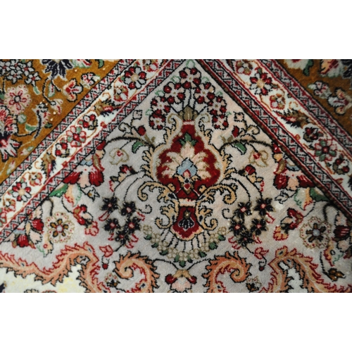 1301 - A FINE 20TH CENTURY SILK RUG, 400 knot count, decorated with foliage, vines and flower heads, centra... 