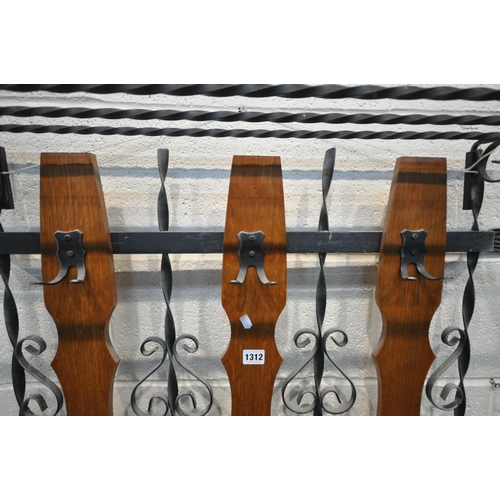 1312 - A WROUGHT IRON WALL HANGING COAT RACK, with detachable shoe shelf to top, and three wooden slats, wi... 