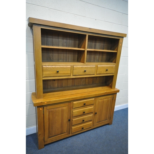 1329 - A SOLID OAK DRESSER, oak furniture land, Hercules Range, with open shelving and draw storage, while ... 