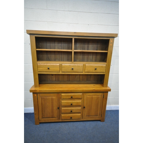 1329 - A SOLID OAK DRESSER, oak furniture land, Hercules Range, with open shelving and draw storage, while ... 